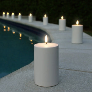 Weather resistant outdoor candle creating poolside ambience